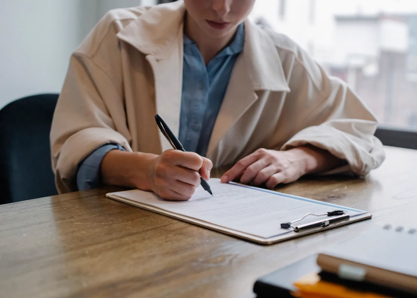 Une recruteuse prend des notes pendant un entretien.